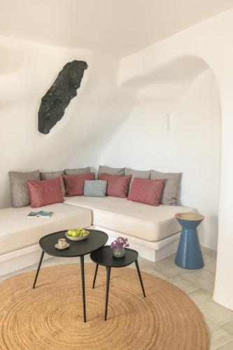 a living room with a couch and two tables at Porto Fira Suites in Fira