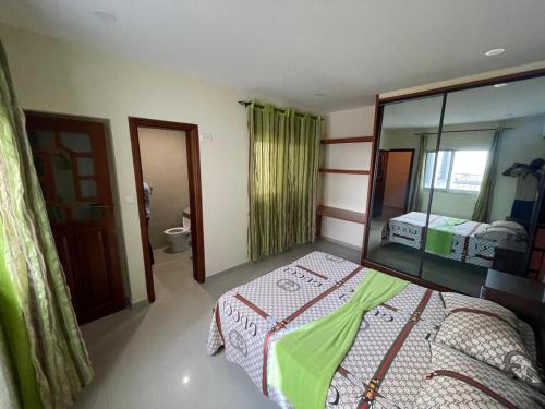 a bedroom with a bed and a mirror at Suites Home Tarrafal in Tarrafal