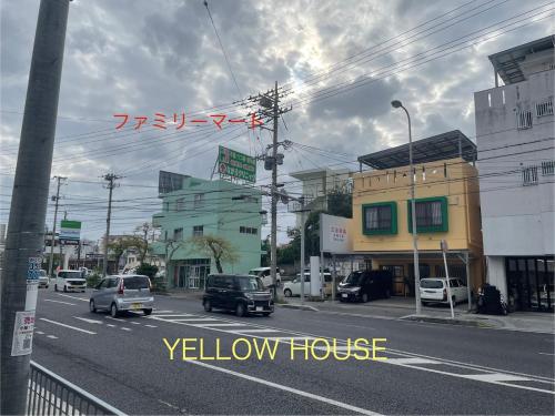 a city street with cars driving down the street at Yellow House Okinawa in Naha