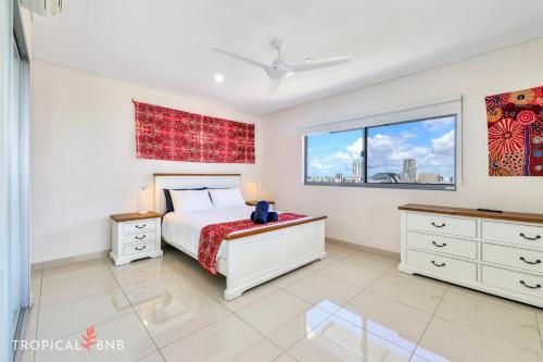 a bedroom with a bed and a window at Penthouse Vibes Amazing Views From Top Floor in Darwin