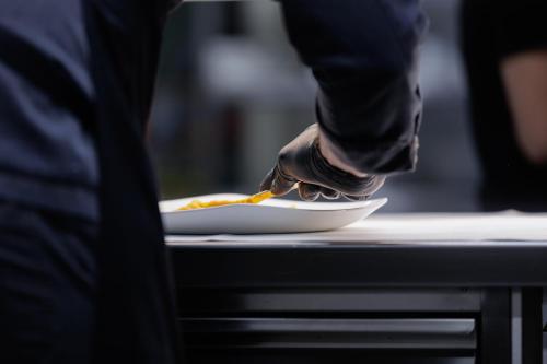 a person with their foot on a plate of food at HOTEL & SPA Goldene Rose in Dinkelsbühl