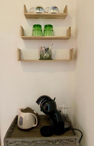 a table with a tea pot and a toaster on it at Alpenpension Gasthof in Ratten