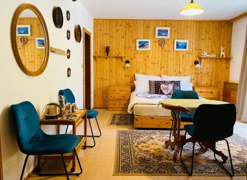 a bedroom with a bed and a table and chairs at Alpenpension Gasthof in Ratten