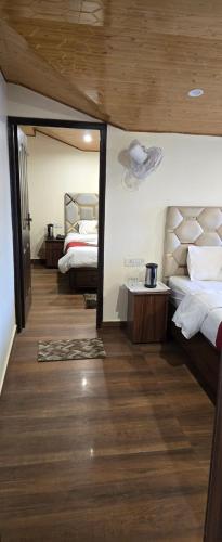 Postel nebo postele na pokoji v ubytování Ambrosia Grand