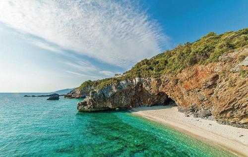 a view of a beach with a rocky cliff at Dandy Villas Tsagkarada - Blue Pansy - Mini Pool in Tsagarada
