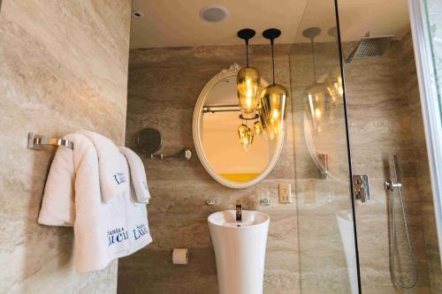 a bathroom with a shower and a mirror and a sink at Santa Lucia Boutique Hotel in Santa Luċija