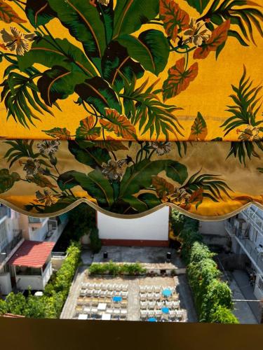 a room with a mural of plants on the wall at Sea and Cinema in Loutraki