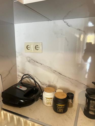 a counter top with a counter top with a stove and aether at Sea and Cinema in Loutraki
