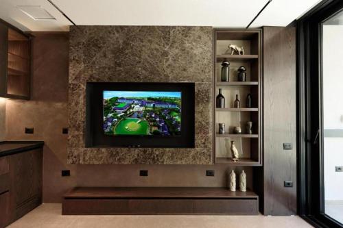 a living room with a flat screen tv on a wall at Hotel Miramare in Vlorë