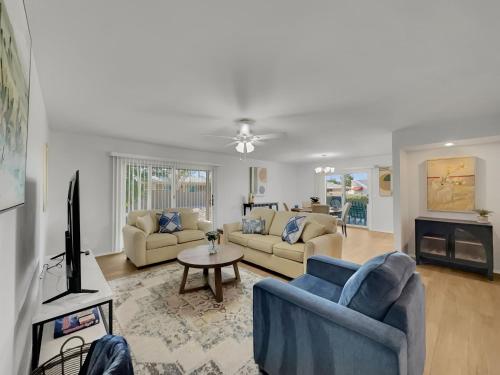 a living room with two couches and a tv at Truro Sun Lakes in Sun Lakes