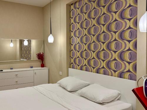 a bedroom with a large painting on the wall at Park Azure 0568 in Baku