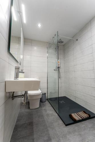 a bathroom with a shower and a sink and a toilet at el rincon de tetuan in Santander