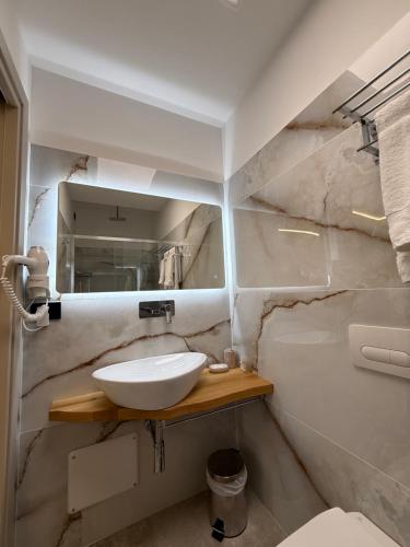 a bathroom with a sink and a mirror at Bonocore Accomodation in Tropea