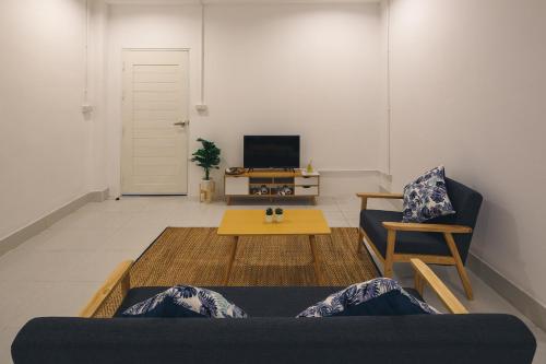 a living room with a couch and a table at Yindee Travellers Lodge in Nan