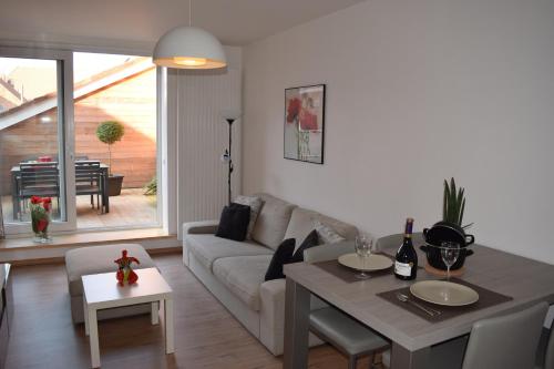 a living room with a couch and a table at Apartment Aurora in Ieper