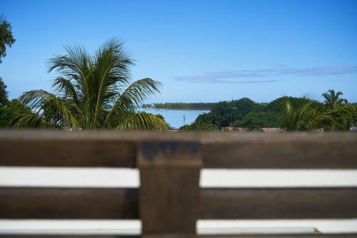 a view of the ocean from a park bench at Loukaz -entire Rental Units W Panoramic Rooftop in La Gaulette