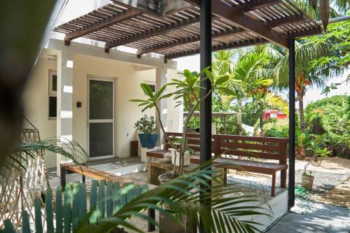 a porch with a wooden bench and plants at Loukaz -entire Rental Units W Panoramic Rooftop in La Gaulette