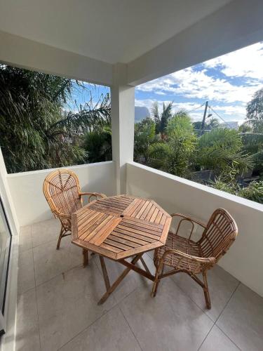 a patio with a table and two chairs on a balcony at Loukaz -entire Rental Units W Panoramic Rooftop in La Gaulette