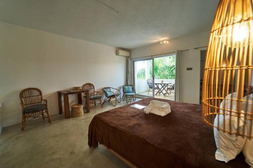 a bedroom with a bed and a table and chairs at Loukaz -entire Rental Units W Panoramic Rooftop in La Gaulette
