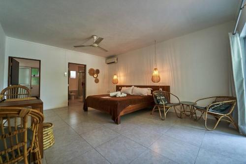 a bedroom with a bed and a table and chairs at Loukaz -entire Rental Units W Panoramic Rooftop in La Gaulette
