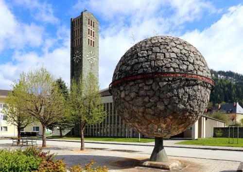 a large egg statue in front of a building with a clock tower at Juwel in Trieben