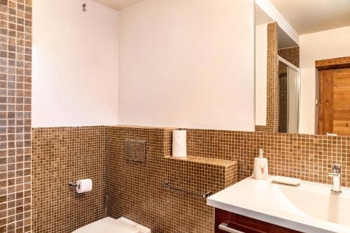 a bathroom with a sink and a toilet and a mirror at Haus Gabriel - Seefeld in Seefeld in Tirol