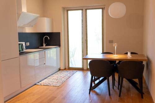 a kitchen with a table and chairs in a room at La Villetta Nicolini in Barbaresco