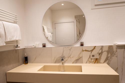 a bathroom with a sink and a mirror at La Villetta Nicolini in Barbaresco