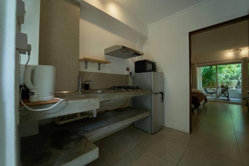 a kitchen with a sink and a refrigerator at Loukaz -entire Rental Units W Panoramic Rooftop in La Gaulette
