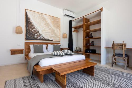 a bedroom with a bed and a wooden table at Villa Shepherd Zanzibar - LUXURY BEACH FRONT - KIWENGWA in Kumba Urembo
