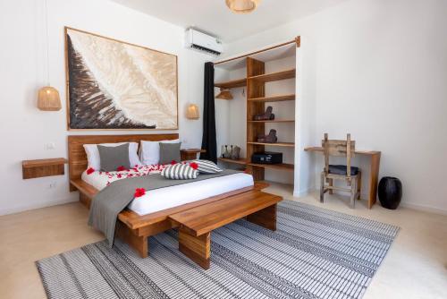 a bedroom with a large bed and a table at Villa Shepherd Zanzibar - LUXURY BEACH FRONT - KIWENGWA in Kumba Urembo