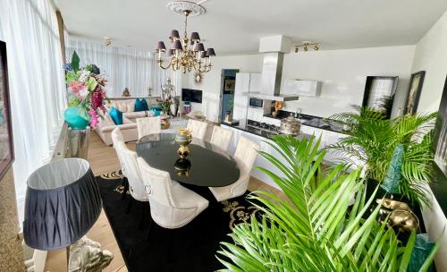 a living room with a table and white chairs at Luxury City Center apartment with Canal view 1 kingsize bed and 1 sleeping sofa in Amsterdam