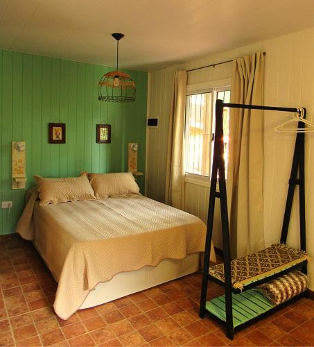 a bedroom with a bed and a ladder in it at VerdeMonte - Cabaña Guatambú in Leandro N. Alem
