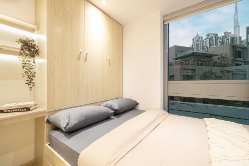 a bedroom with a bed and a large window at Next'Living - Luxury Private Room in a CoLiving Villa in Dubai