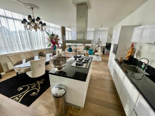 a kitchen and living room with a table and a counter top at Luxury City Center apartment with Canal view 1 kingsize bed and 1 sleeping sofa in Amsterdam