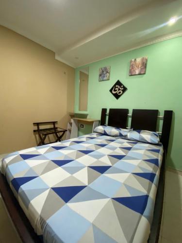 a bedroom with a blue and white checkered bed at NaPoles valledupar Hotel in Valledupar