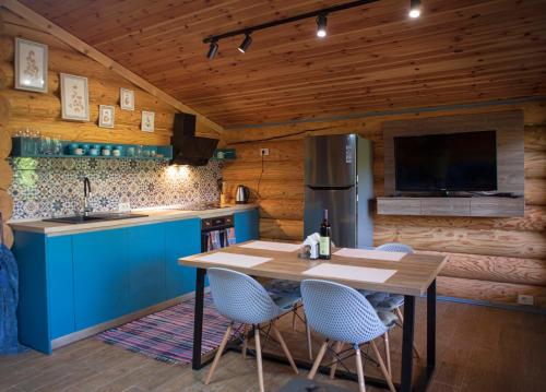 a kitchen with a table and chairs and a refrigerator at Vucje Brdo in Kolasin in Kolašin