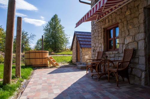a patio with a table and chairs outside of a building at Vucje Brdo in Kolasin in Kolašin
