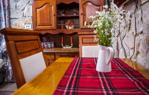 a table with a vase of flowers on a table at Vucje Brdo in Kolasin in Kolašin