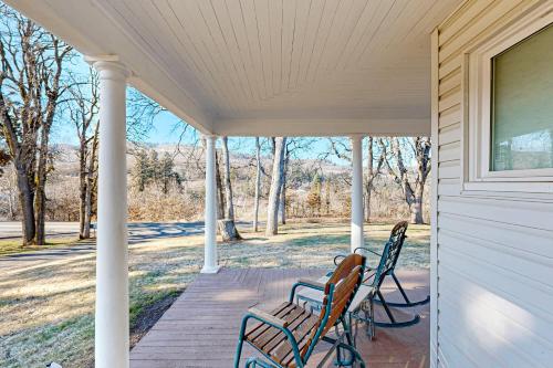 two chairs sitting on the porch of a house at The Carroll House in Mosier
