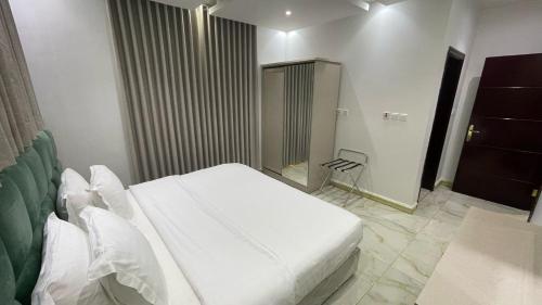 a bedroom with a white bed in a room at Developed view Hotel in Jeddah