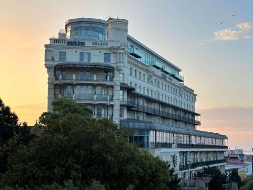 a tall white building with a sunset in the background at Park Inn by Radisson Palace in Southend-on-Sea