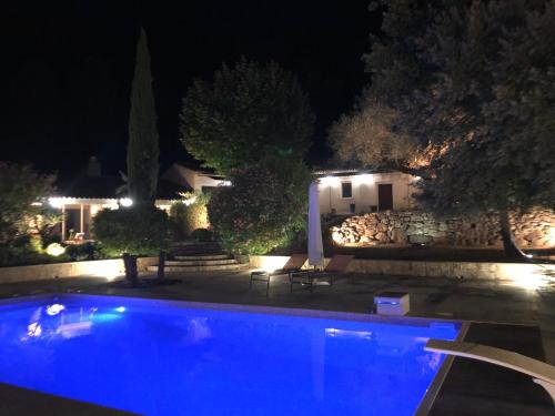 a swimming pool in front of a house at night at Propriété : 300 M² + (25 M² d'annexe / Pool House) sur 5 ha boisé à 10' d'Aix en Provence in Beaurecueil