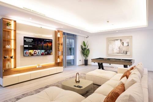 a living room with a couch and a piano at Next'Living - Luxury Private Room in a CoLiving Villa in Dubai