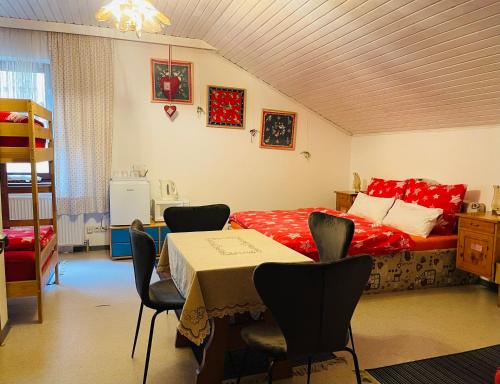 a bedroom with a bed and a table and chairs at Alpenpension Gasthof in Ratten