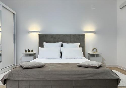 a bedroom with a large bed with two pillows at Inga Oasis in Turda