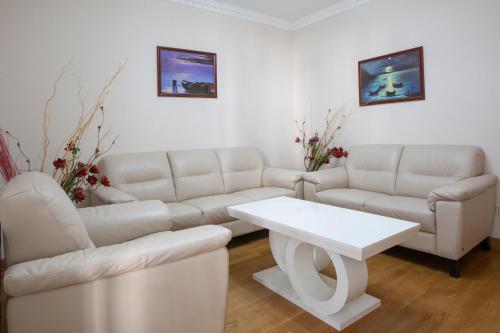a living room with a couch and a table at Montesan Luxury Apartments Sveti Stefan in Sveti Stefan