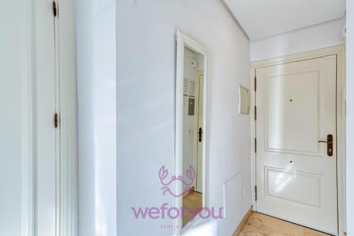 a white hallway with a white door and a white door at weforyou Old Town Benalmadena in Benalmádena