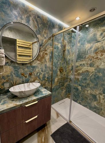 a bathroom with a shower with a sink and a mirror at Los Locos Luxury in Torrevieja
