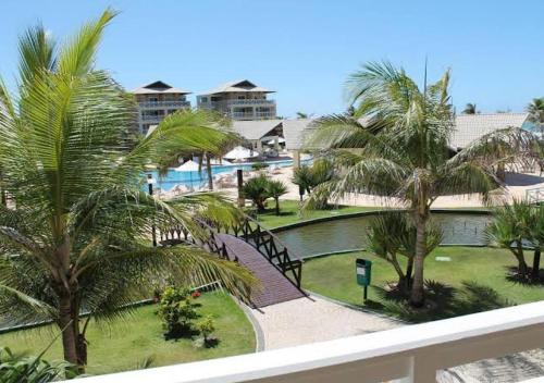 a view from the balcony of a resort with palm trees at Apartamento com cobertura no Portamaris Resort in Aquiraz